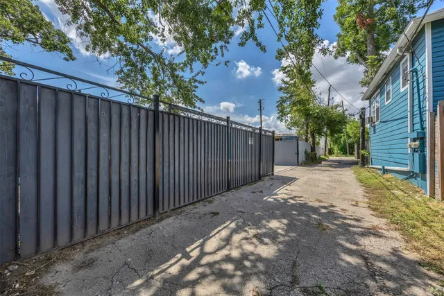 a view of a backyard with wooden fence