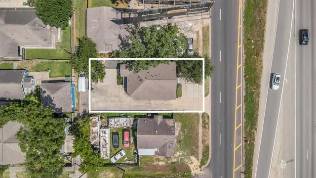 an aerial view of a house with a swimming pool