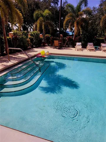 a view of a swimming pool with an outdoor space and seating area