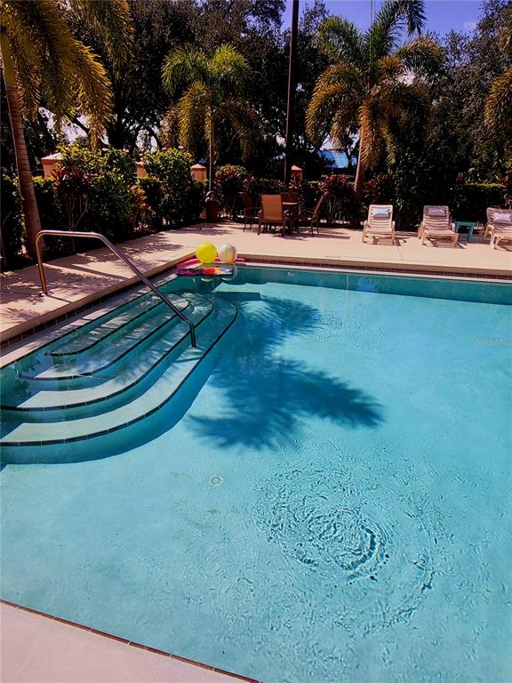 3000 Maingate Lane, Unit 517 Kissimmee, FL 34747 - Photo 13 of 13 a view of a swimming pool with an outdoor space and seating area
