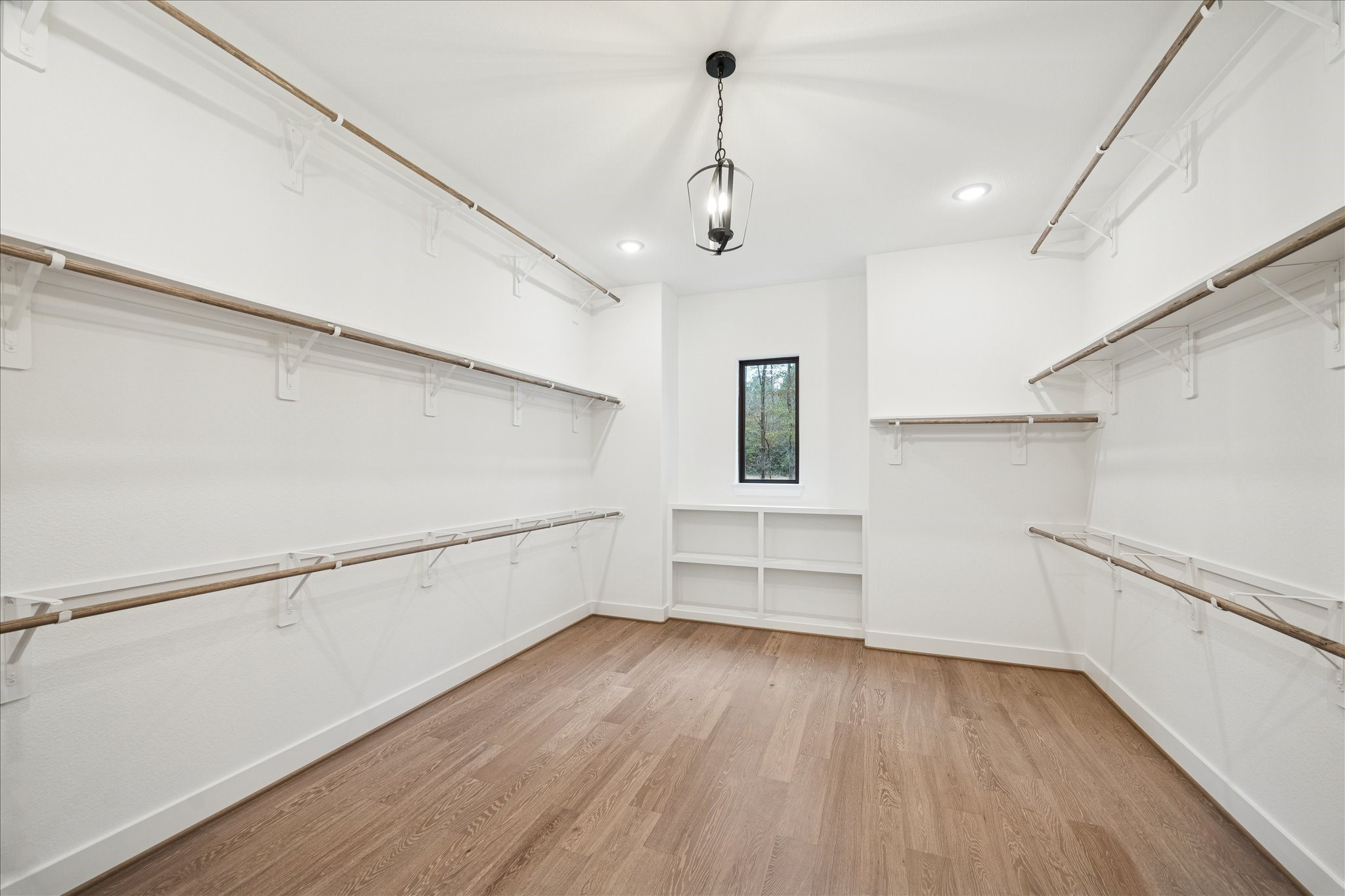 104 Dawn Court Huntsville, TX 77340 - Photo 20 of 37 a view of walk in closet with wooden floor