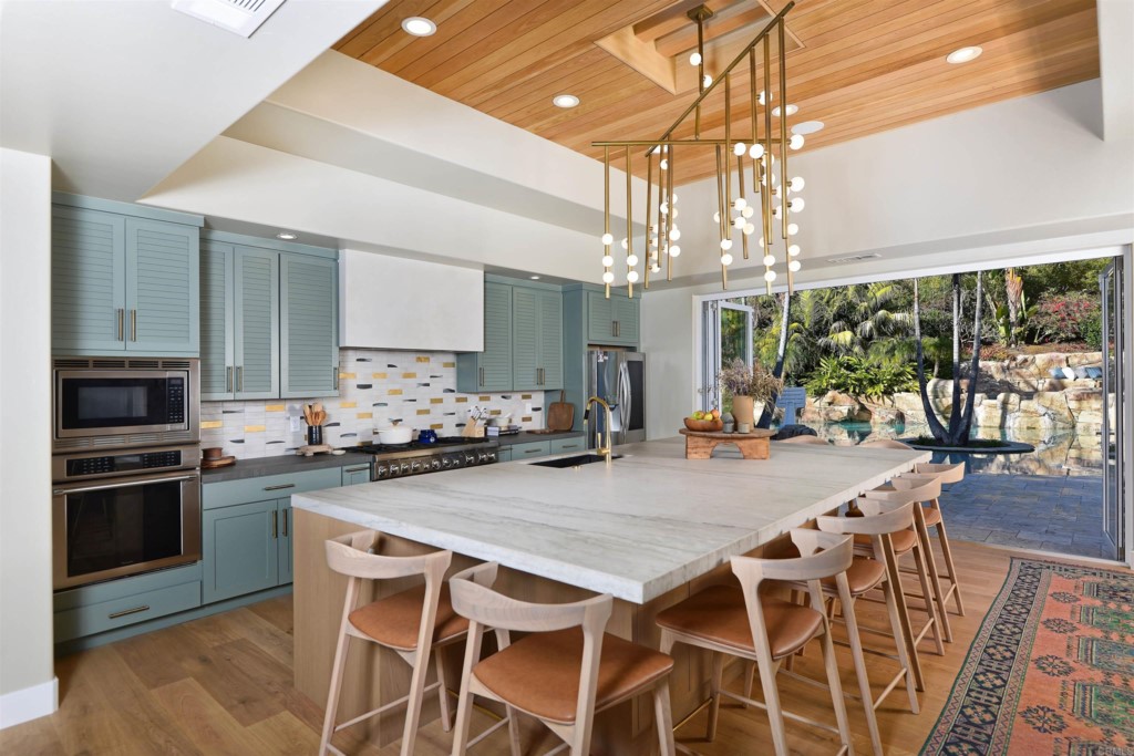 1264 Rancho Encinitas Drive Encinitas, CA 92024 - Photo 12 of 37 a kitchen with a table and chairs in it