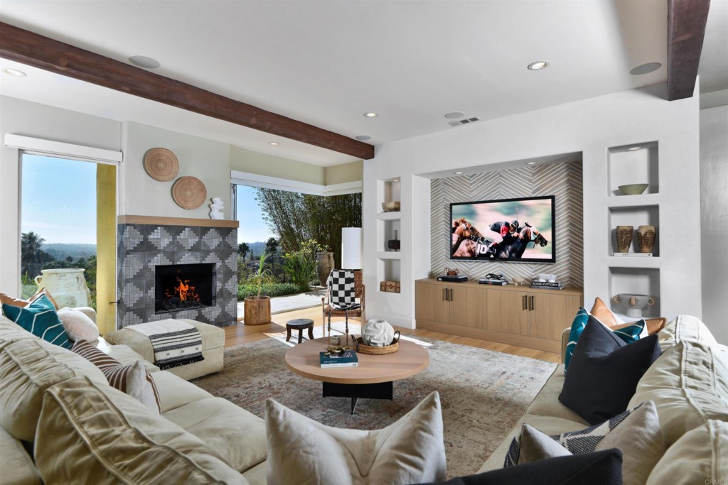 1264 Rancho Encinitas Drive Encinitas, CA 92024 - Photo 13 of 37 a living room with furniture a fireplace and a flat screen tv