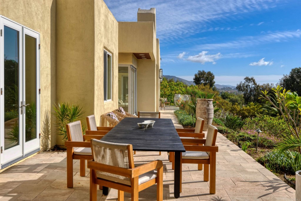 1264 Rancho Encinitas Drive Encinitas, CA 92024 - Photo 15 of 37 a table and chairs sitting in front of a door