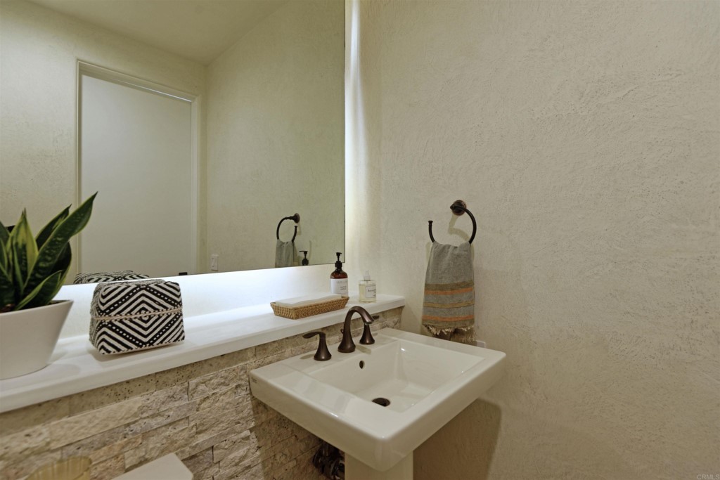 1264 Rancho Encinitas Drive Encinitas, CA 92024 - Photo 23 of 37 a bathroom with a sink and a mirror