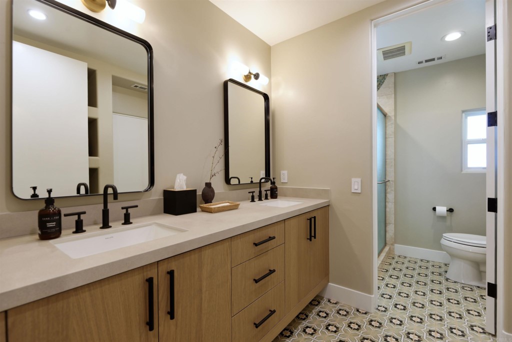 1264 Rancho Encinitas Drive Encinitas, CA 92024 - Photo 24 of 37 a bathroom with a double vanity sink mirror and toilet