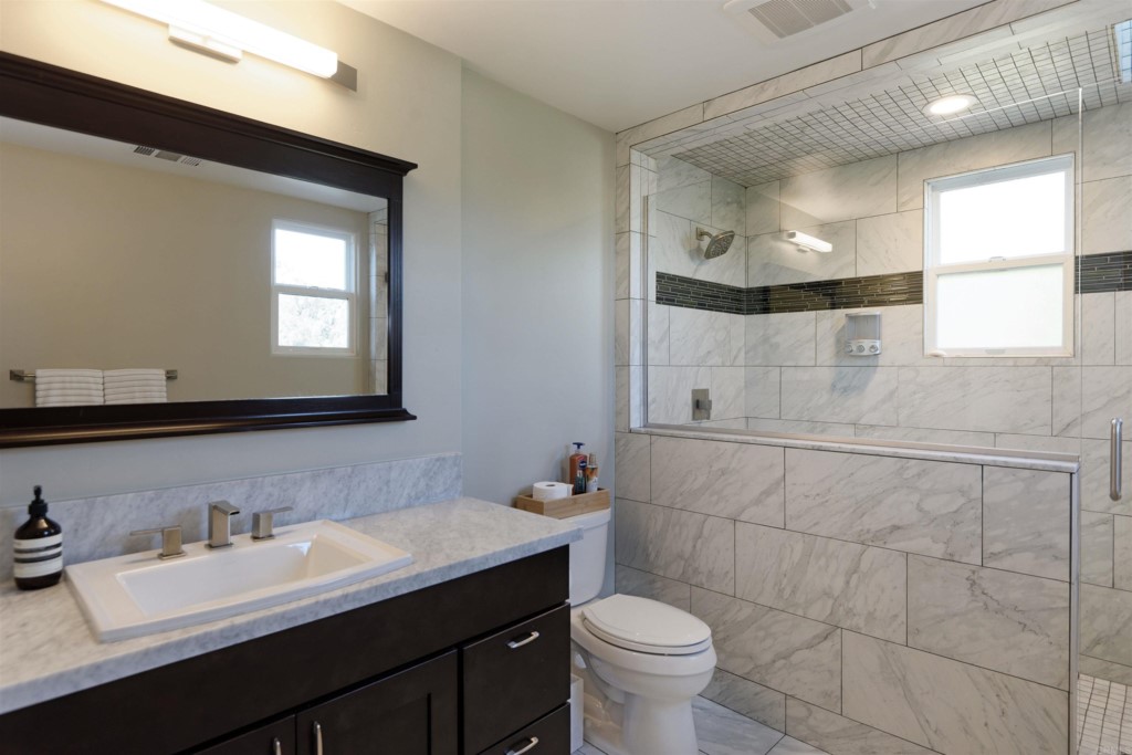 1264 Rancho Encinitas Drive Encinitas, CA 92024 - Photo 28 of 37 a bathroom with a sink toilet a mirror and window