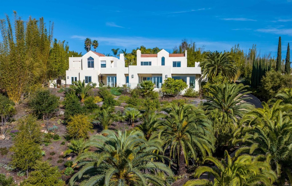 1264 Rancho Encinitas Drive Encinitas, CA 92024 - Photo 34 of 37 a view of a white house with a big yard and large trees