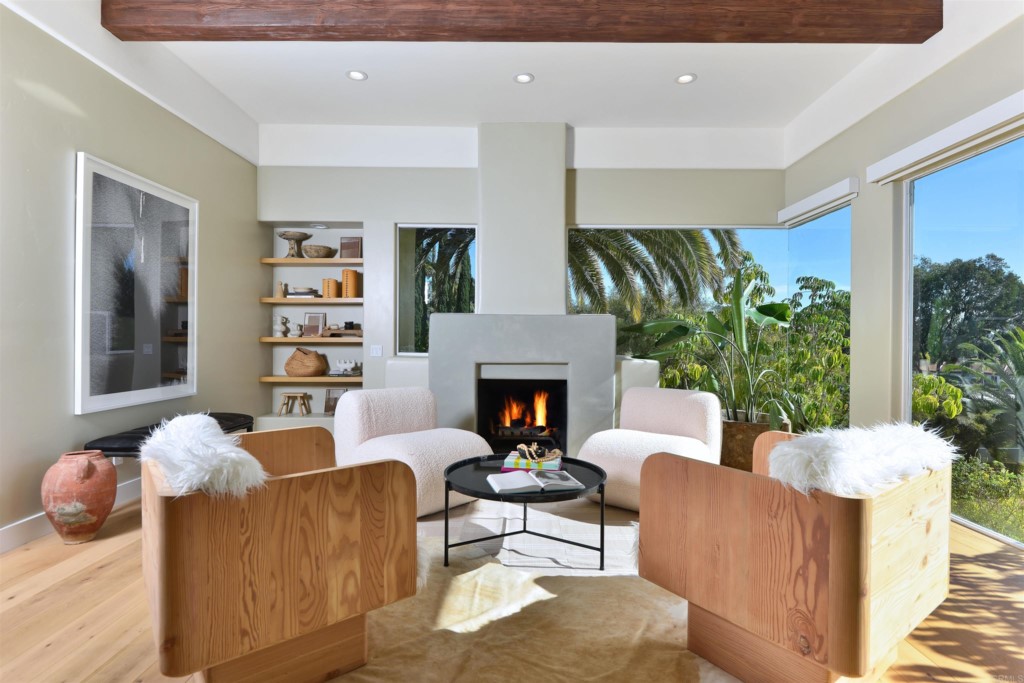 1264 Rancho Encinitas Drive Encinitas, CA 92024 - Photo 8 of 37 a living room with furniture potted plant and a fireplace