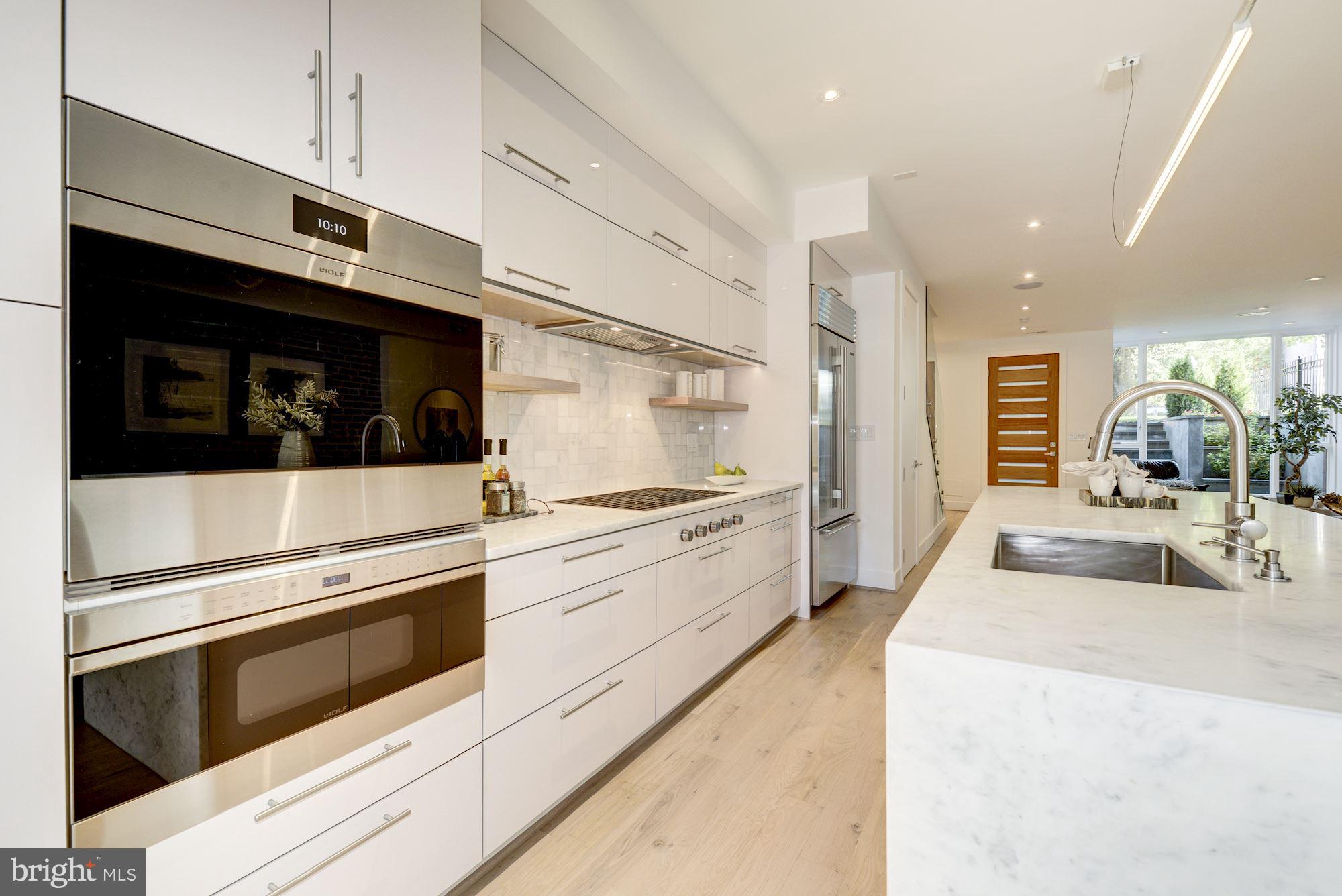 505 K Street Northeast, Unit 2 Washington, DC 20002 - Photo 8 of 18 a large white kitchen with stainless steel appliances