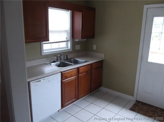 a kitchen with a sink window and cabinets