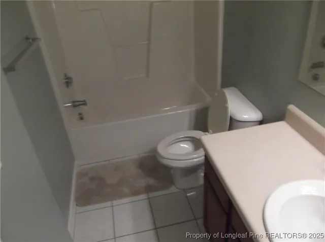 a white toilet sitting next to a bath tub
