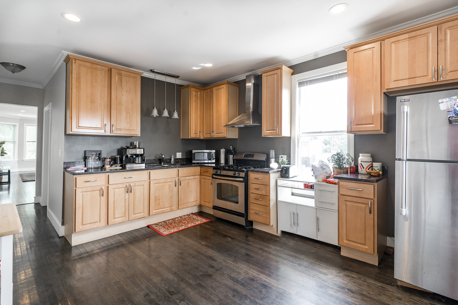 2310 North Kenneth Avenue, Unit 3 Chicago, IL 60639 - Photo 2 of 11 a kitchen with granite countertop white cabinets and white appliances