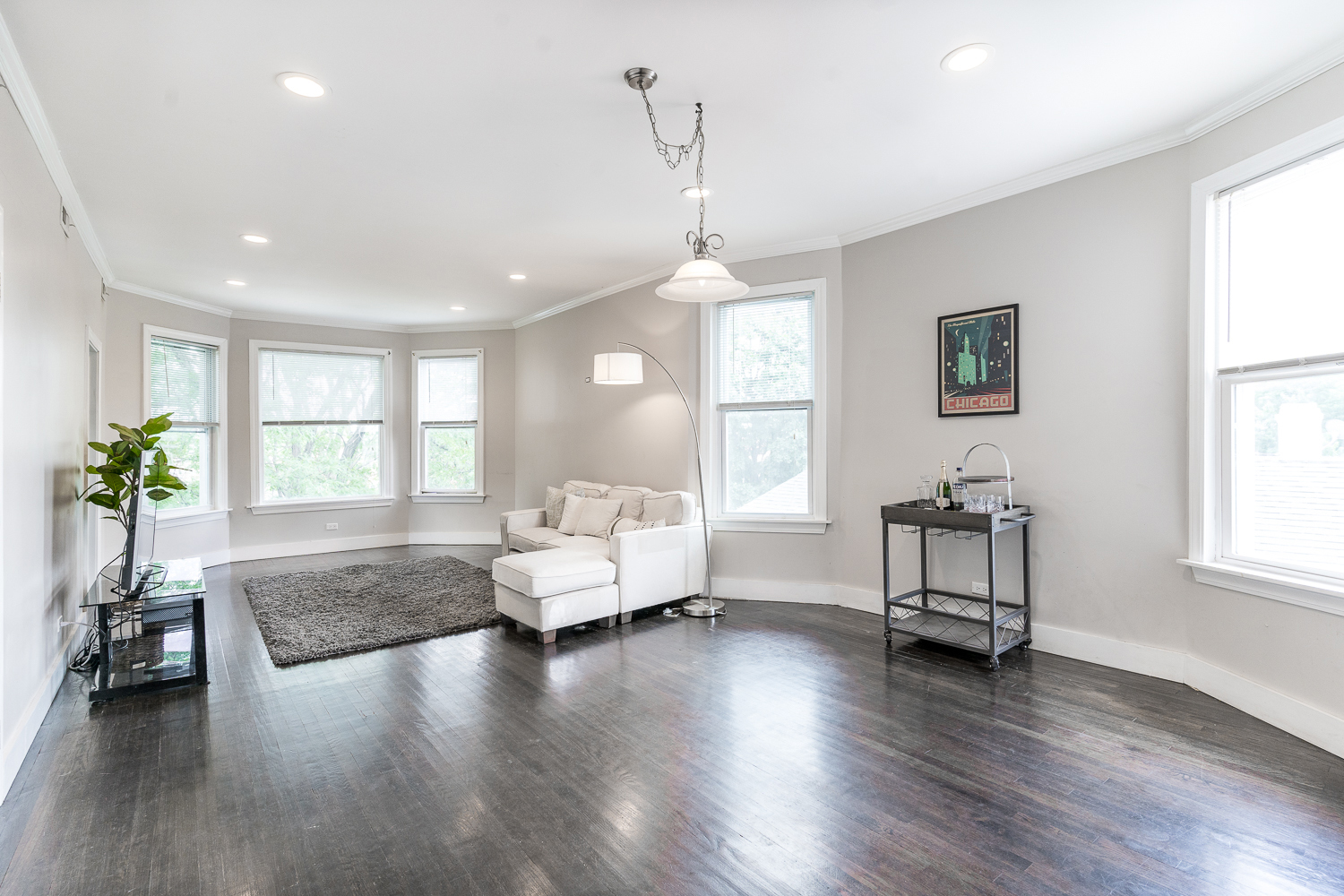 2310 North Kenneth Avenue, Unit 3 Chicago, IL 60639 - Photo 4 of 11 a living room with couches and a large window