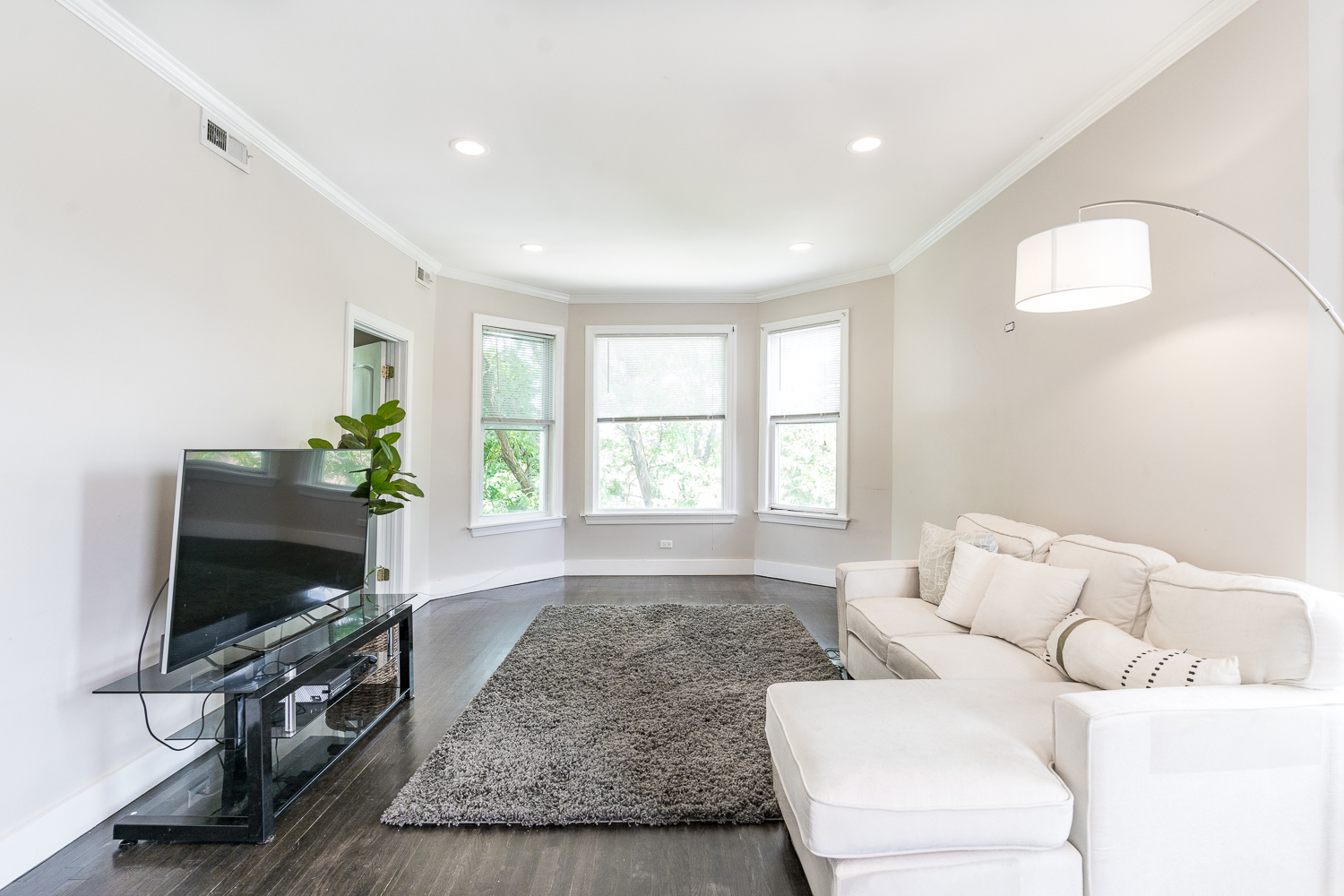 2310 North Kenneth Avenue, Unit 3 Chicago, IL 60639 - Photo 6 of 11 a living room with furniture and a flat screen tv