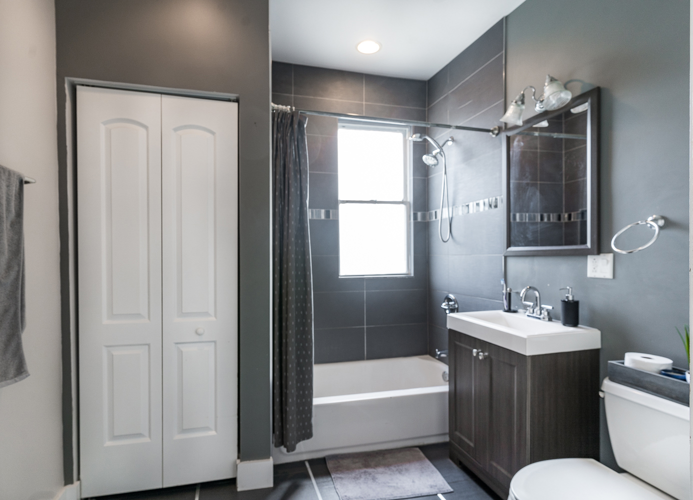 2310 North Kenneth Avenue, Unit 3 Chicago, IL 60639 - Photo 10 of 11 a bathroom with a sink toilet and shower