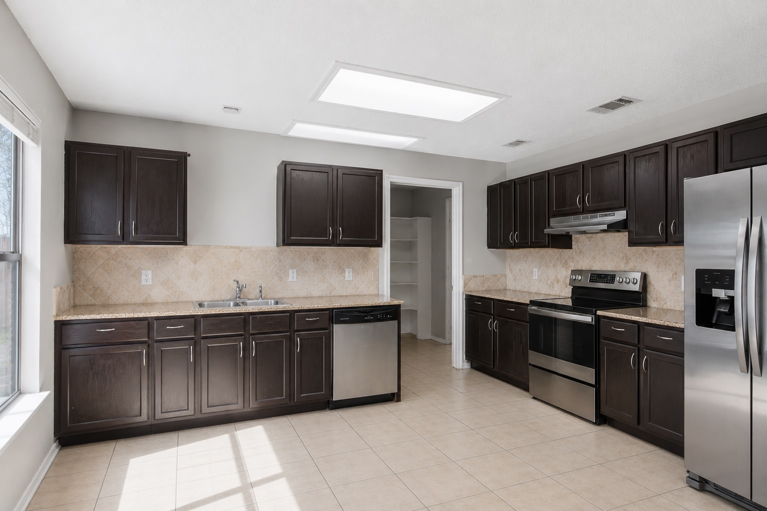 7900 Rosenberry Drive Austin, TX 78747 - Photo 11 of 27 A well-equipped culinary space awaits with extensive cabinetry and modern appliances.