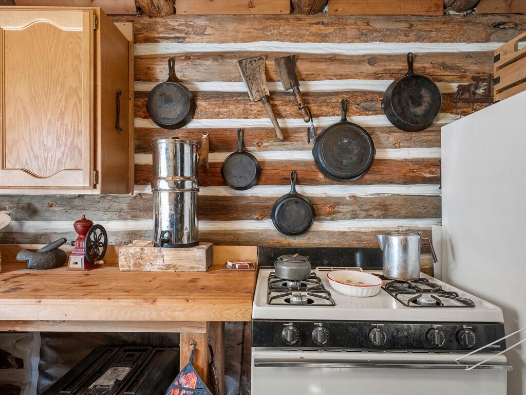 507 Secesh River Road McCall, ID 83638 - Photo 22 of 34 Gas range and a wall of cast iron cookware.