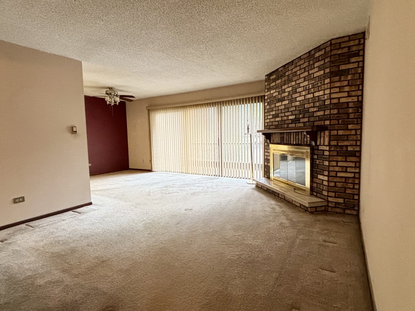 9168 S Road, Unit A Palos Hills, IL 60465 - Photo 4 of 14 a view of an empty room with a fireplace and a window