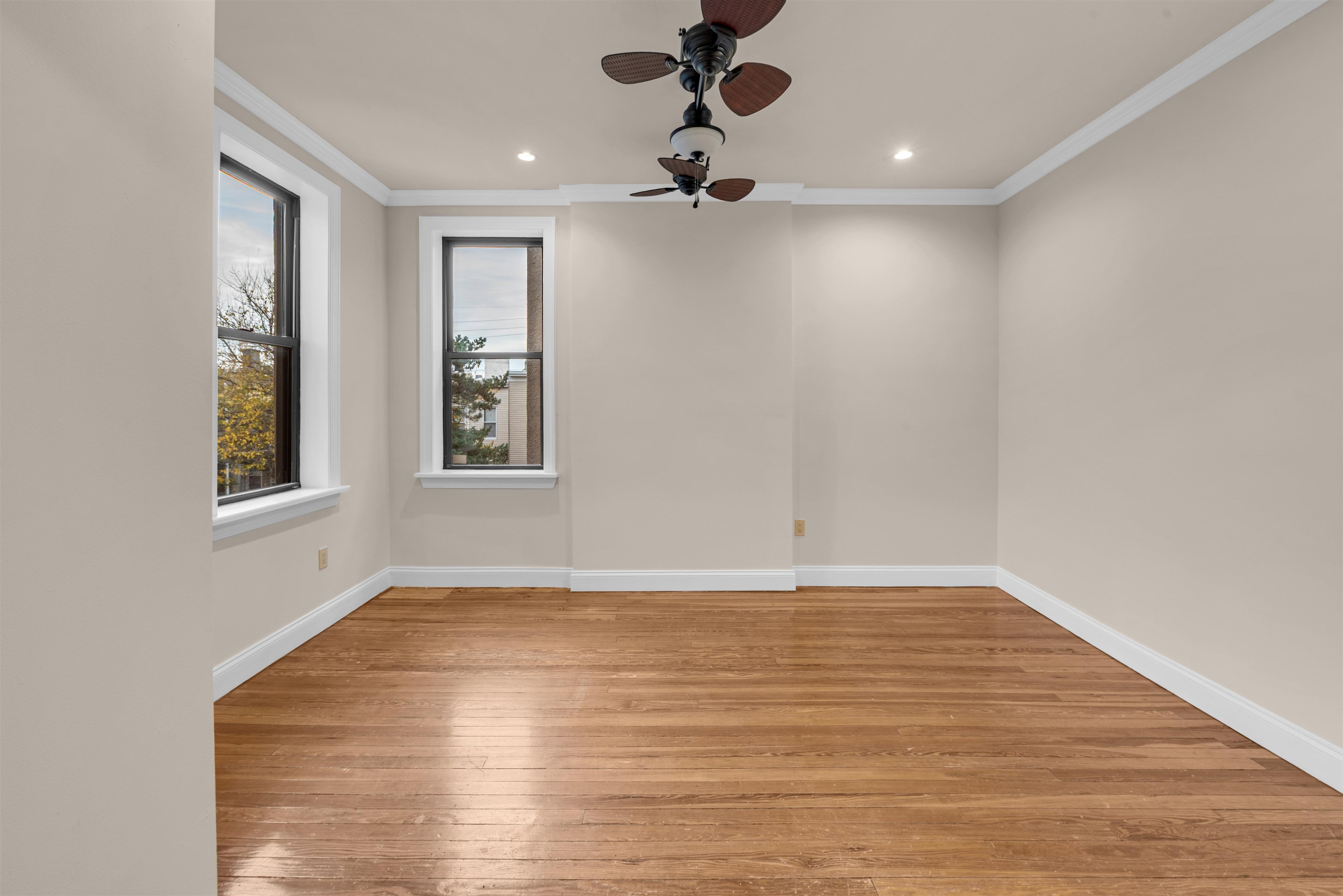 312 Monastery Place, Unit 2R Union City, NJ 07087 - Photo 7 of 15 wooden floor in an empty room with a window