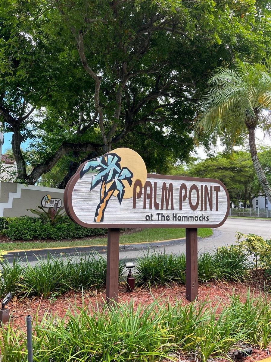 a view of a street sign under a large tree