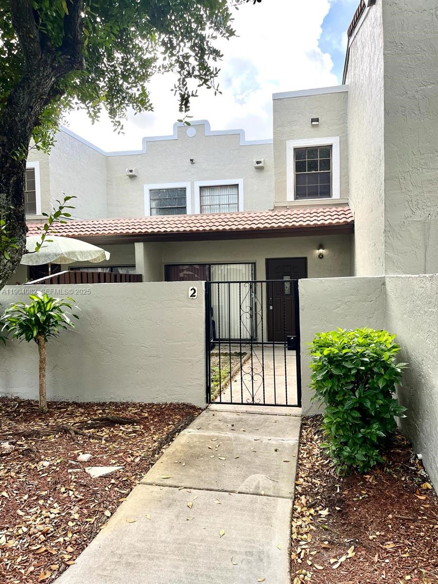 10445 Southwest 154th Court, Unit 2 Miami, FL 33196 - Photo 2 of 11 a front view of a house with a porch