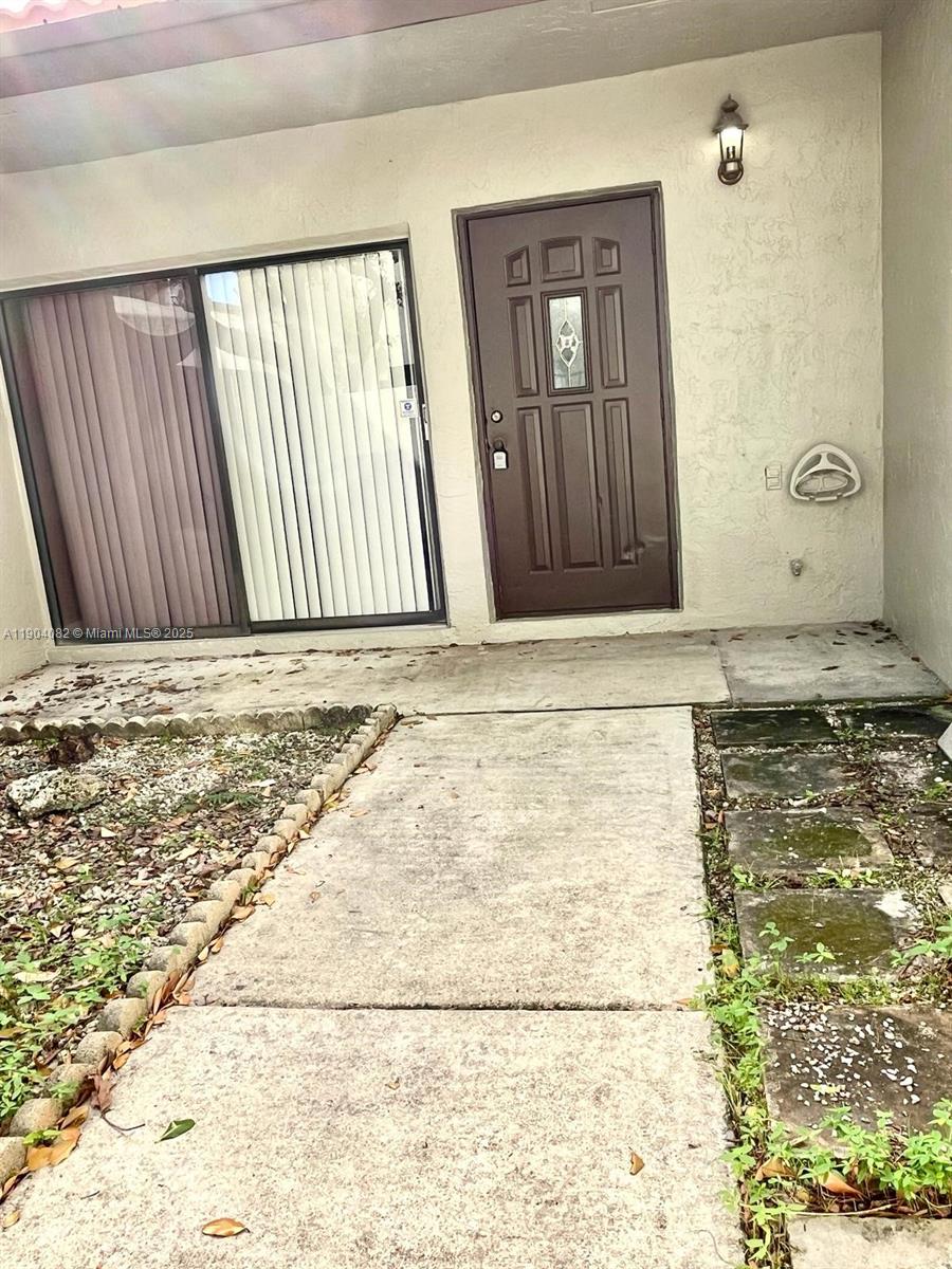 10445 Southwest 154th Court, Unit 2 Miami, FL 33196 - Photo 4 of 11 a view of wooden door