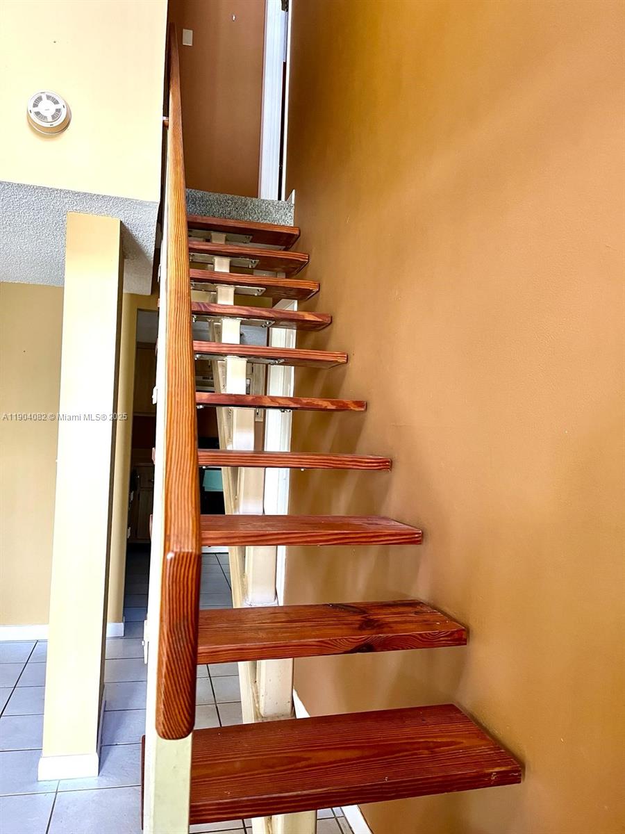 10445 Southwest 154th Court, Unit 2 Miami, FL 33196 - Photo 6 of 11 a view of staircase with white walls