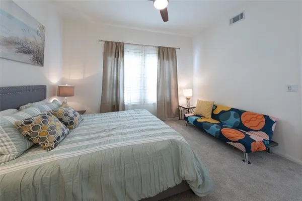 a bedroom with a bed and a window