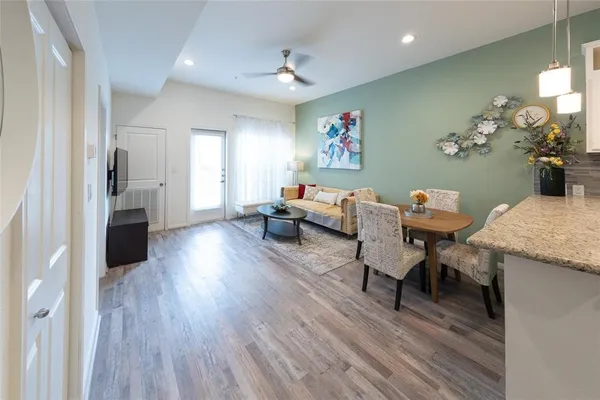 a living room with furniture and wooden floor