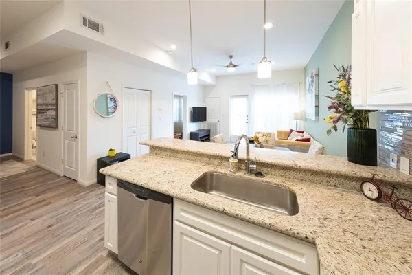 a bathroom with a granite countertop sink a large mirror and vanity