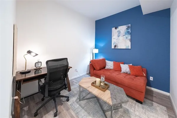 a reading room with furniture and a chair