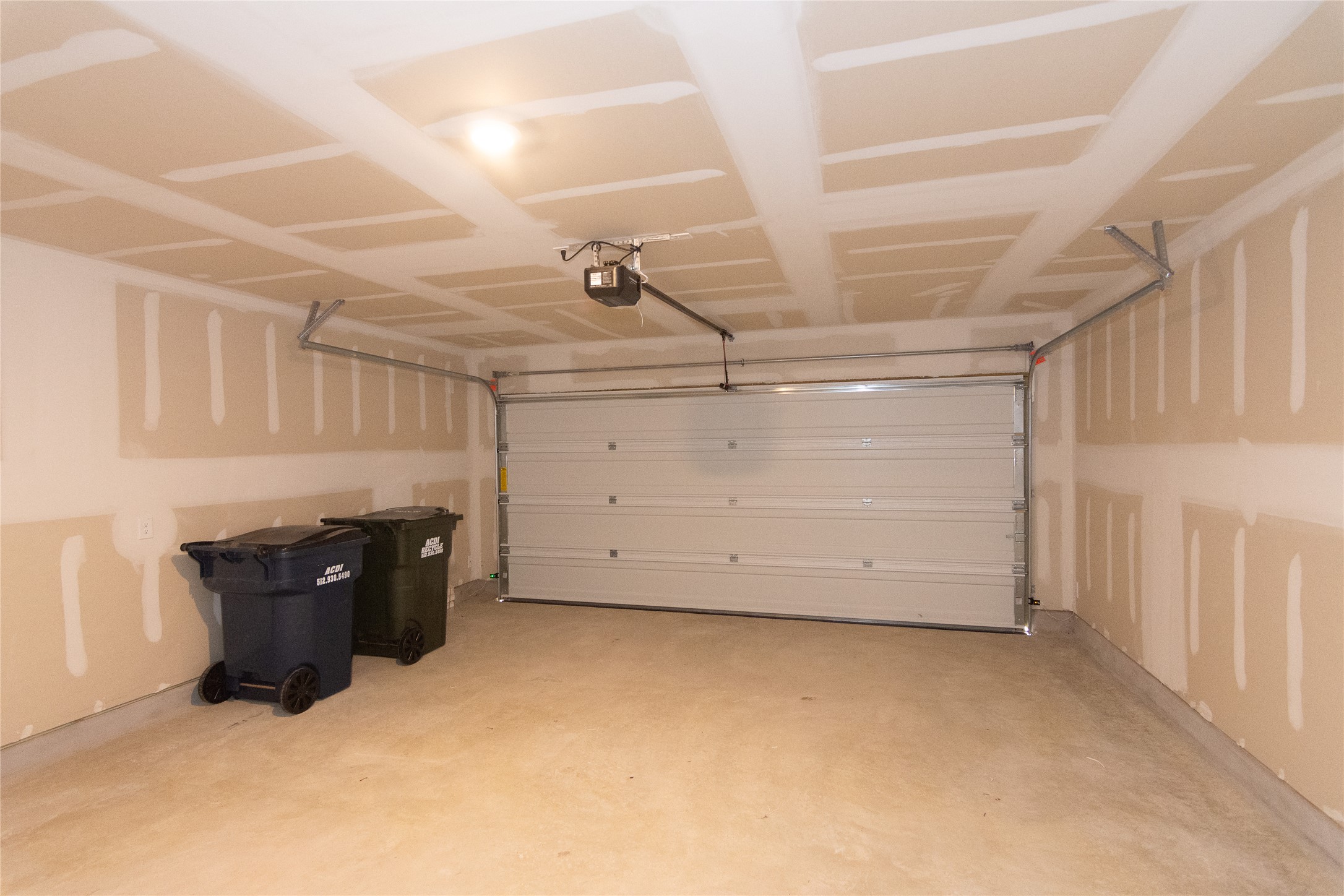 149 Star Packer Lane Jarrell, TX 76537 - Photo 24 of 30 A spacious, clean garage offers ample parking and storage with a convenient automatic door.