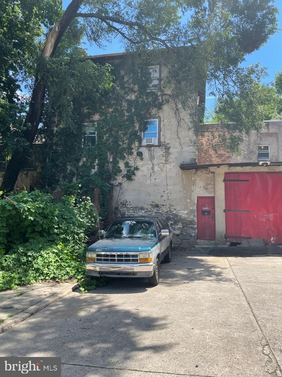 a car parked in front of a brick house