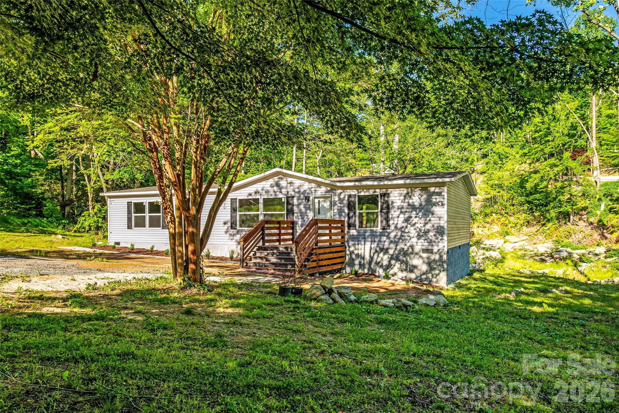 45 Alan Retreat Road Hendersonville, NC 28792 - Photo 6 of 25 a view of a house with garden and tree