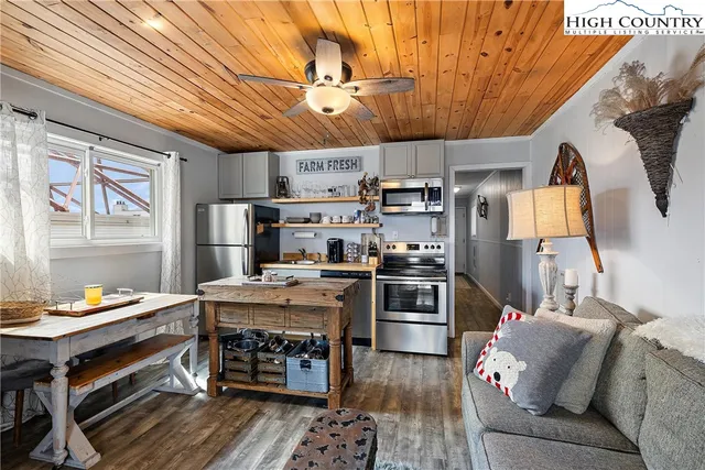 a open kitchen with stainless steel appliances granite countertop a stove and a refrigerator