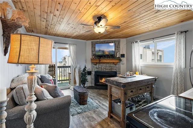a living room with furniture a fireplace and a table