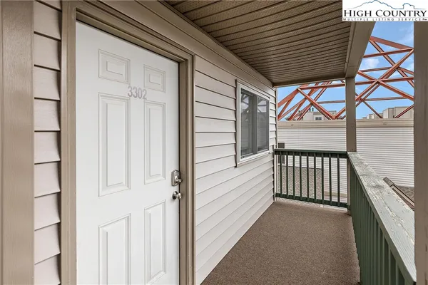 a view of a porch with wooden floor and stairs