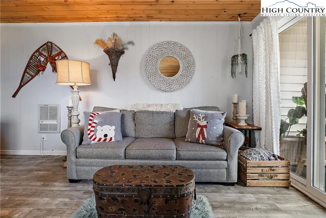 a living room with furniture and a mirror