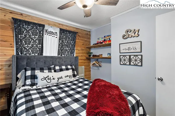 a bedroom with a bed and a mirror