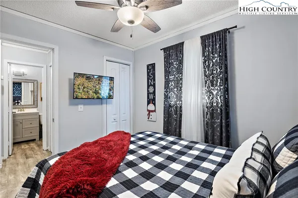 a bedroom with a bed and a chandelier