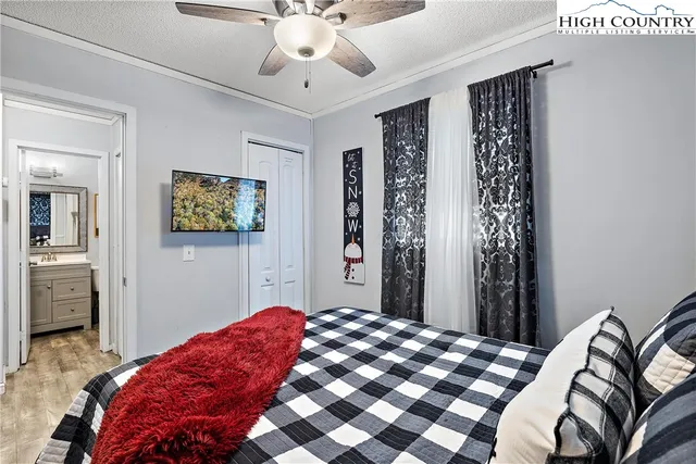 a bedroom with a bed and a chandelier