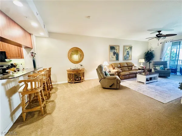 a living room with furniture a window and gym equipment