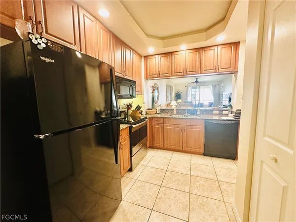 a kitchen with stainless steel appliances a refrigerator sink and cabinets