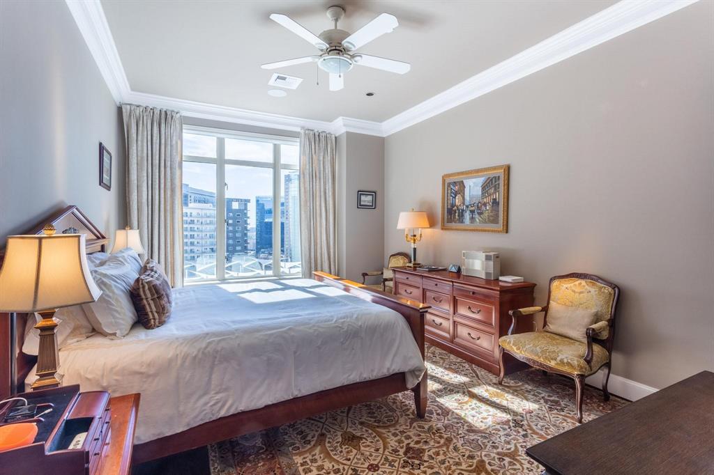 2525 North Pearl Street, Unit 1105 Dallas, TX 75201 - Photo 14 of 38 a bedroom with a bed a chair and a chandelier