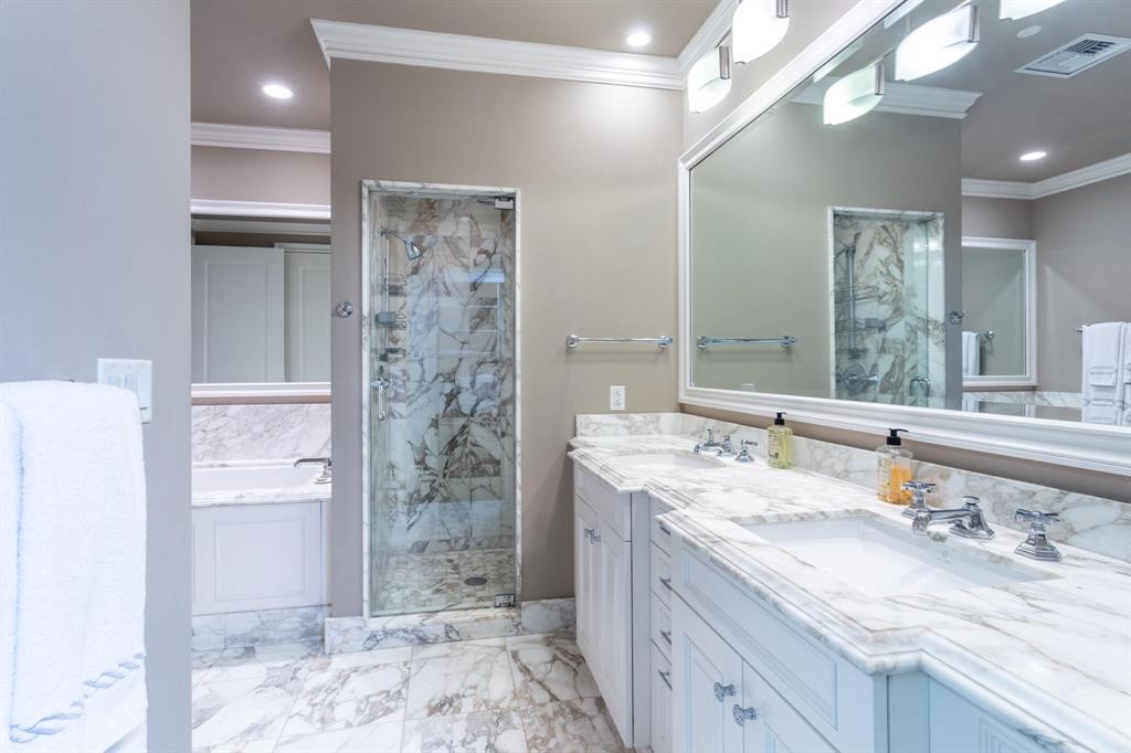 2525 North Pearl Street, Unit 1105 Dallas, TX 75201 - Photo 16 of 38 a bathroom with a granite countertop sink a toilet a large mirror and shower