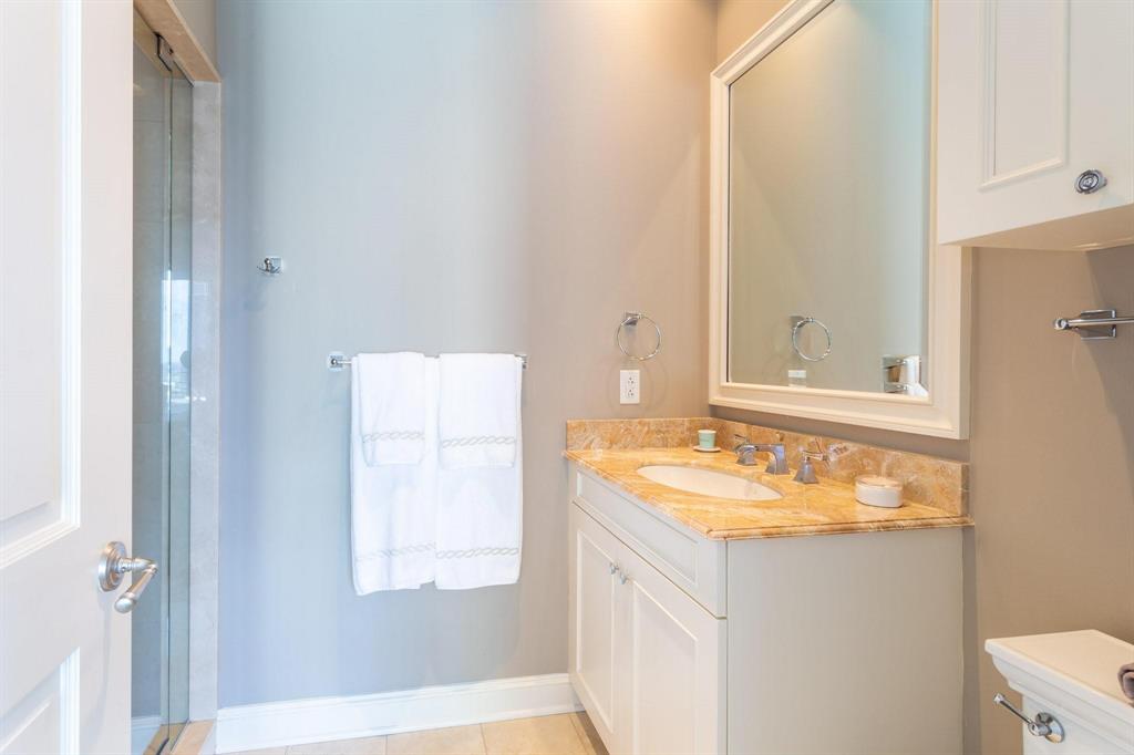 2525 North Pearl Street, Unit 1105 Dallas, TX 75201 - Photo 21 of 38 a bathroom with a granite countertop sink and a mirror