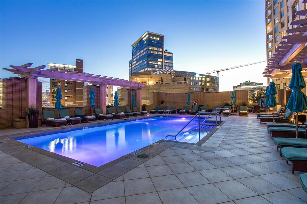 2525 North Pearl Street, Unit 1105 Dallas, TX 75201 - Photo 31 of 38 a view of a swimming pool with red chairs