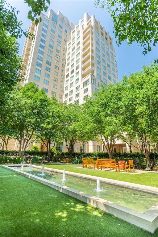 2525 North Pearl Street, Unit 1105 Dallas, TX 75201 - Photo 36 of 38 a view of a swimming pool with a garden and trees