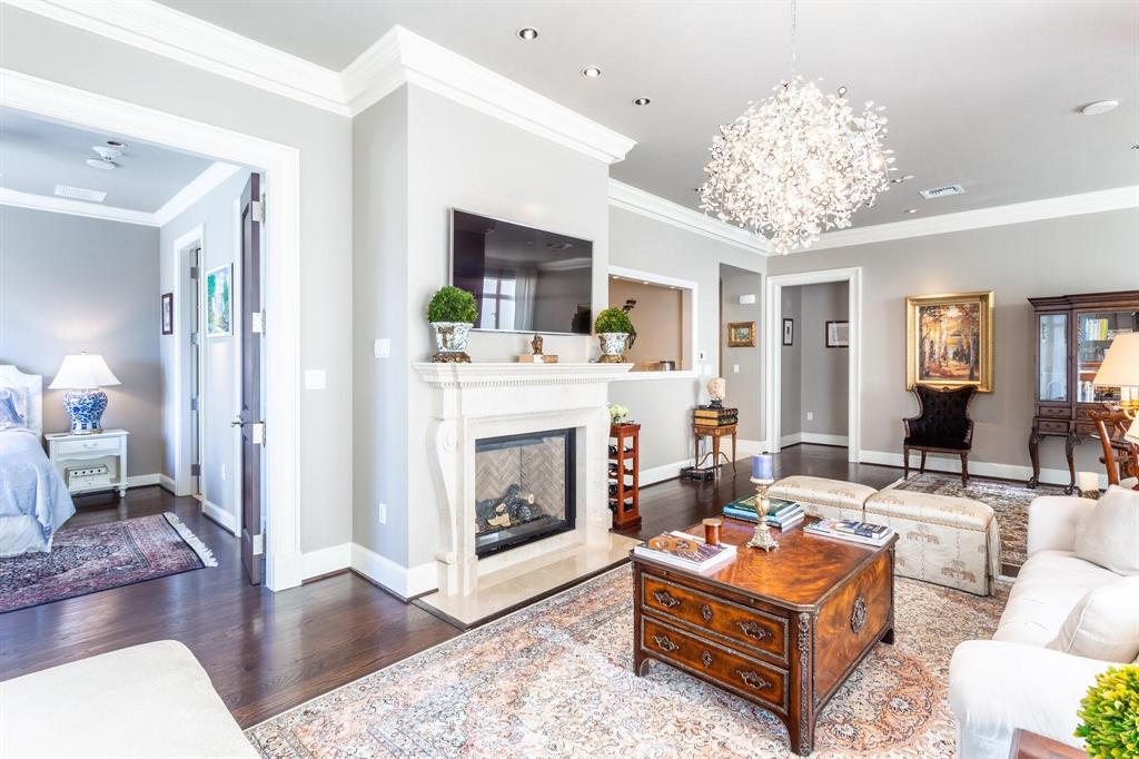 2525 North Pearl Street, Unit 1105 Dallas, TX 75201 - Photo 6 of 38 a living room with furniture a fireplace and a chandelier